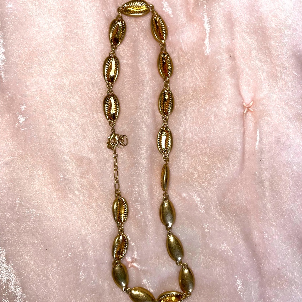 This is a gold shell necklace. Heavy and beautiful. Strong clasp